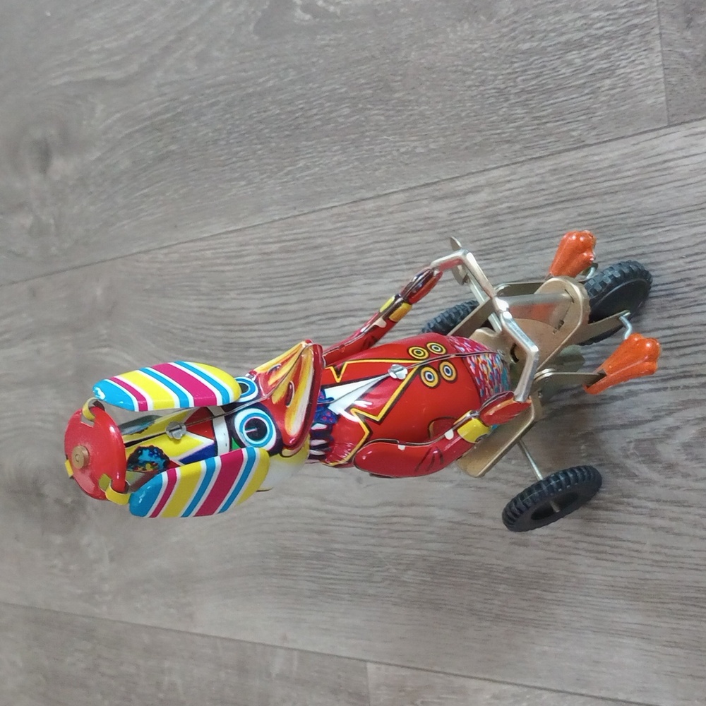 Vintage-style, Wind-up Tin Toy Featuring a Colorful Duck Tiding a Tricycle